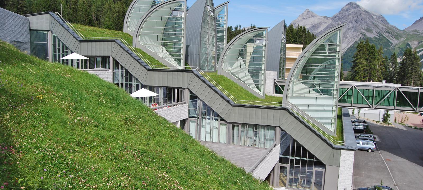 Pitched green roof with lawn and sail-shaped skylights