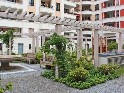 Courtyard with water feature, benches and trellis with climbing plants