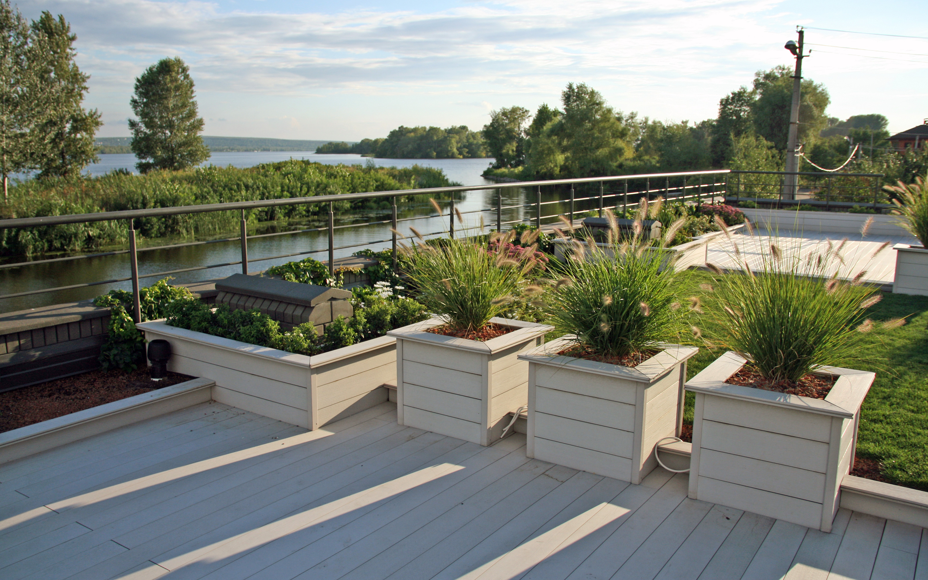 Roof garden with lawn, planters and wooden terrace decking